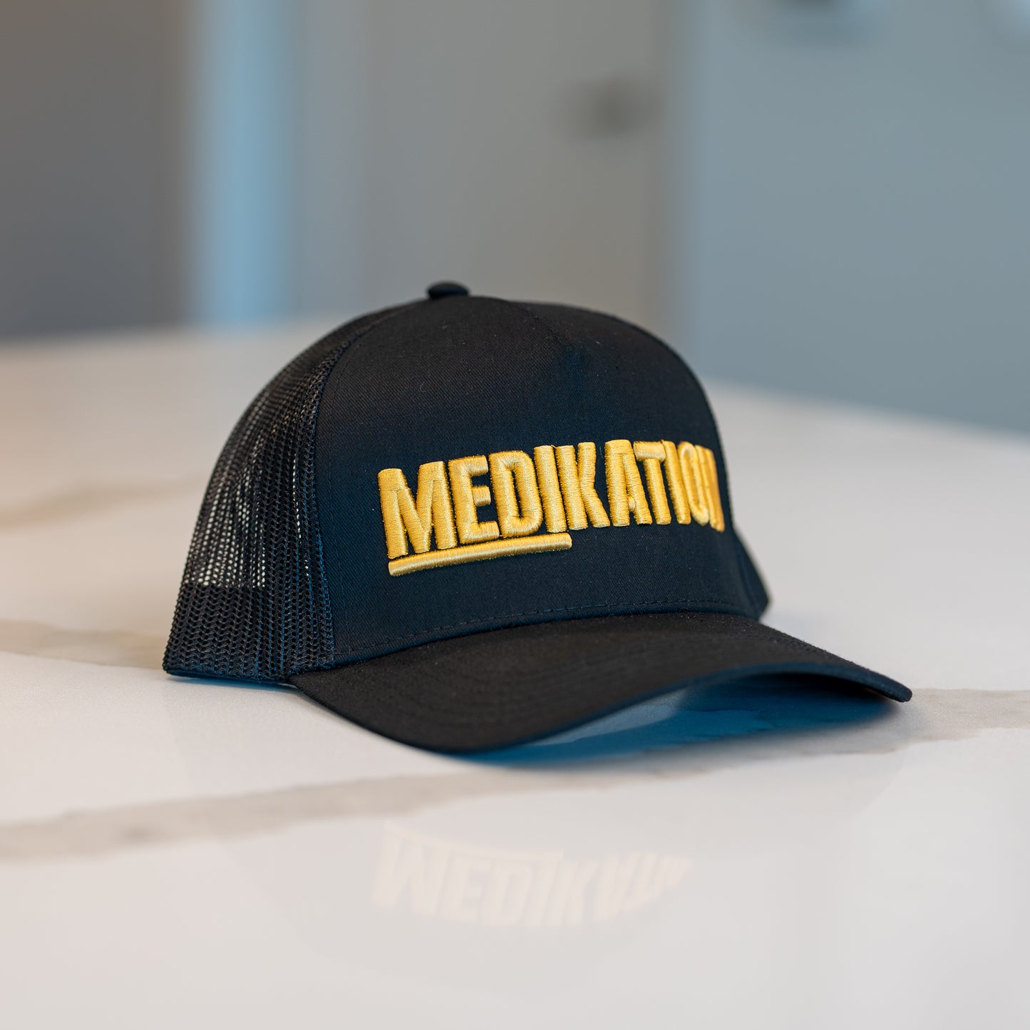 MEDIKATION Gold-Stitch Trucker Hat — front view