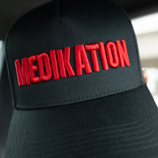 MEDIKATION Red-Stitch Trucker Hat — front view