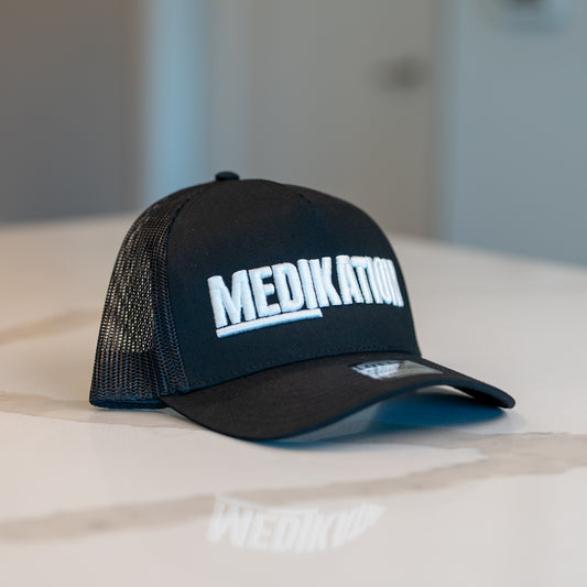 MEDIKATION White-Stitch Trucker Hat — front view